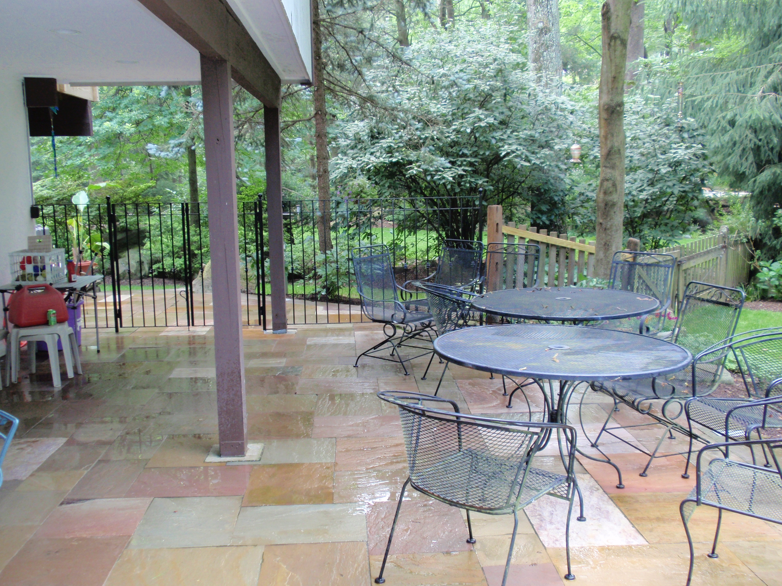 Flagstone patio and stone walls in a Main Line backyard living space