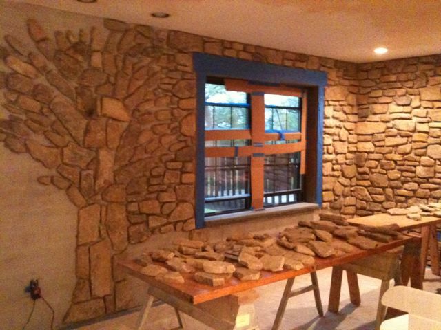 Custom interior stone wall with a tree inlaid in the stonework