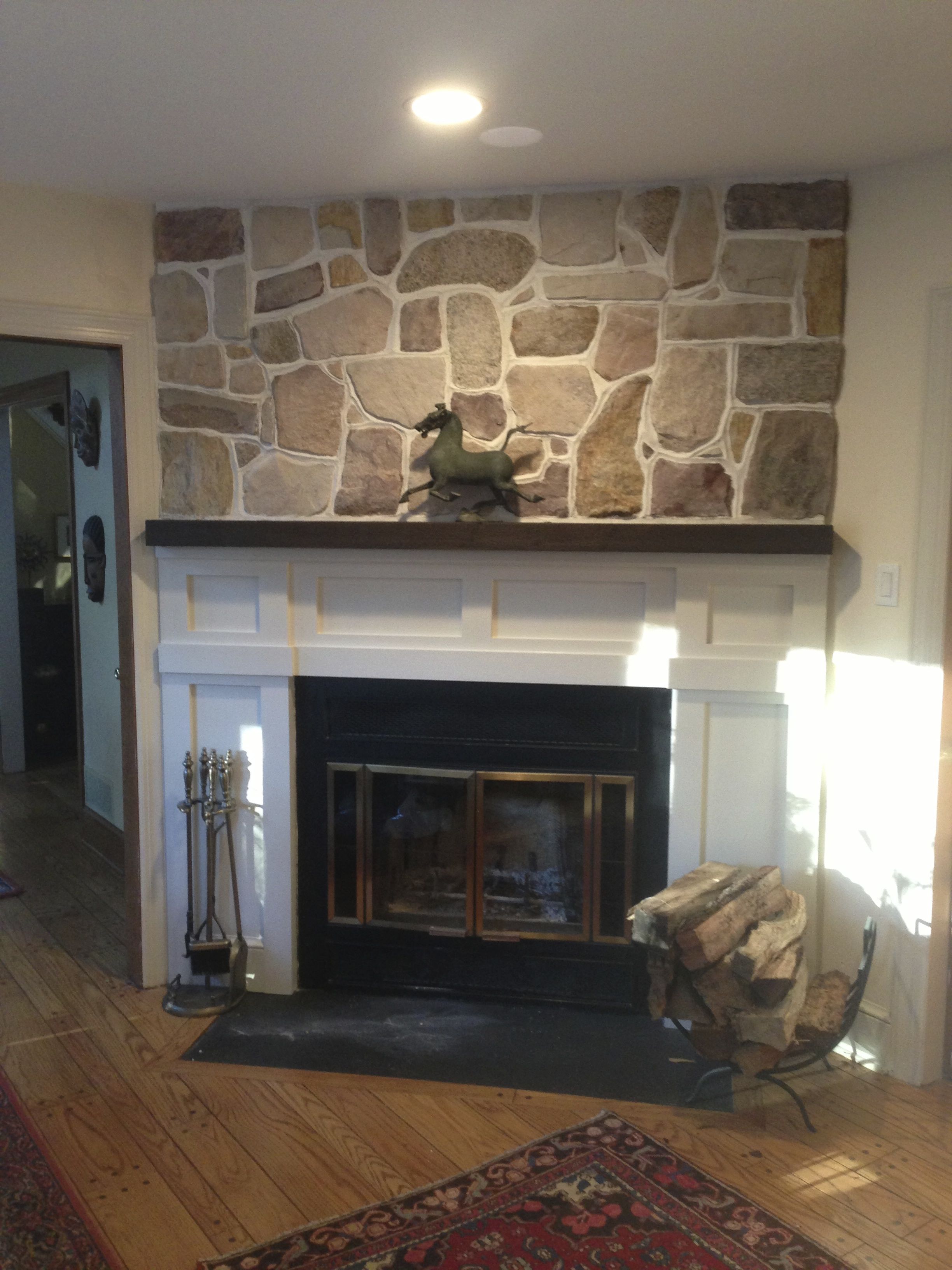 Kitchen with custom stone fireplace and stone accent wall