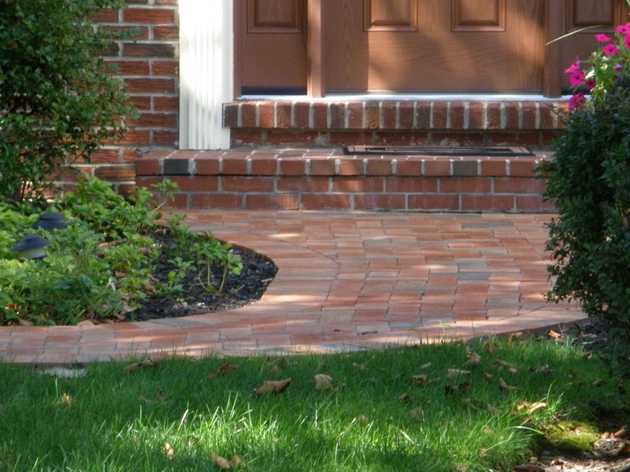 Herringbone brick walkway with stone border